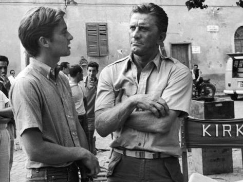 American actor Kirk Douglas (right) and his son American actor Michael Douglas on the set of the film, 'Cast a Giant Shadow,' directed by Melville Shavelson, Rome, Italy, 1965. Kirk had the starring role and Michael had a bit part. (Photo by Hulton Archive/Getty Images)